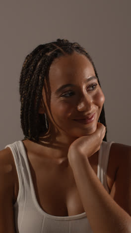 Studio-Beauty-Shot-Of-Smiling-Young-Woman-With-Long-Braided-Hair-Against-Neutral-Background-1